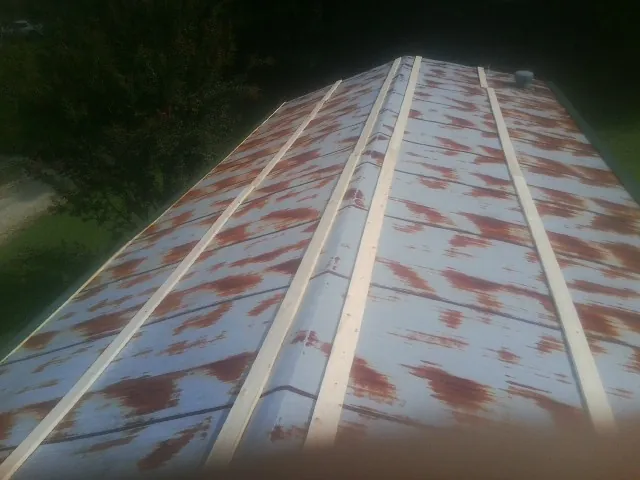 Rusted metal roof panels with new wood purlins before replacement — Storm Damage Roof Repair in Mc Knightstown by Roofing Brothers